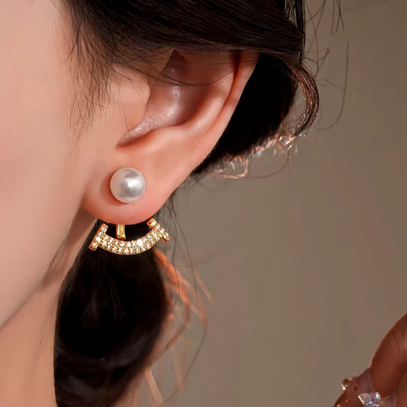 Model showcasing the dangle and style of the 14K Gold-Plated Elegant Zircon Pearl Jacket Earrings