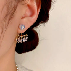 Model showcasing the dangle and style of the 14K Gold-Plated Elegant Zircon Pearl Jacket Earrings