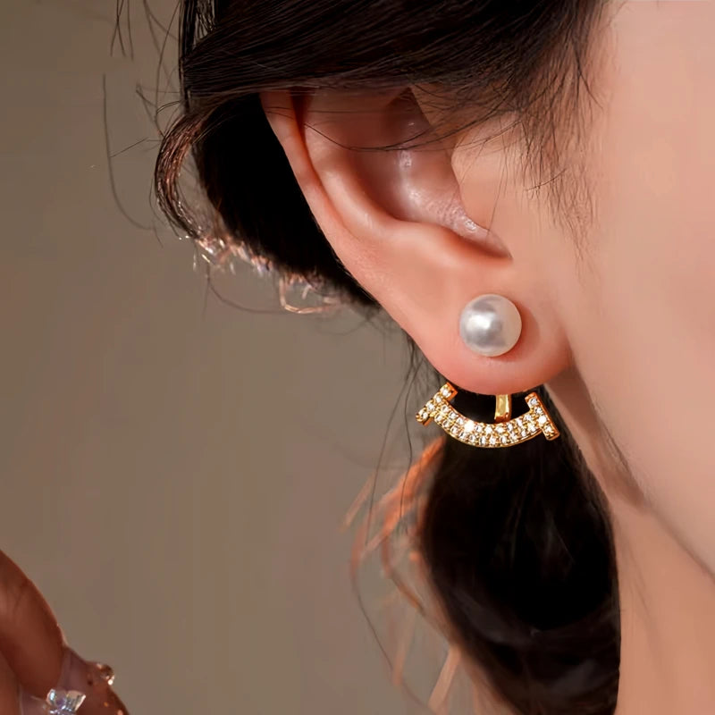 Close-up detail of the sparkling zircons and plating on the gold jacket earrings