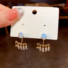 Close-up detail of the sparkling zircons and plating on the gold jacket earrings
