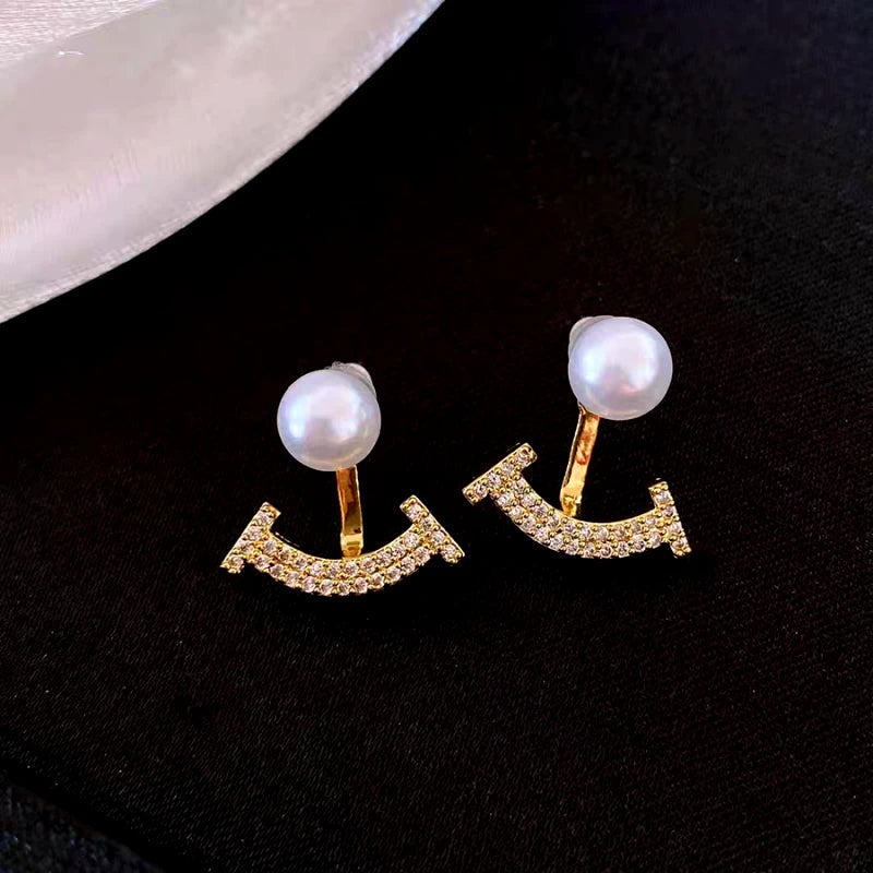 Angled view of the 14K Gold-Plated Elegant Zircon Pearl Jacket Earrings
