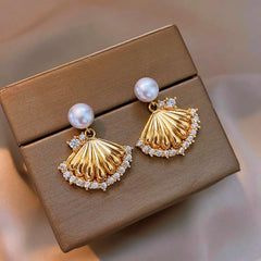 Close-up detail of the sparkling zircons and plating on the gold pearl earrings