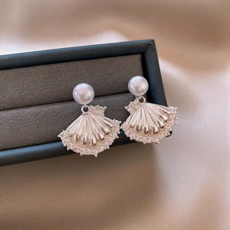 Angled view of the 14K Gold-Plated Elegant Zircon Pearl Shell Earrings