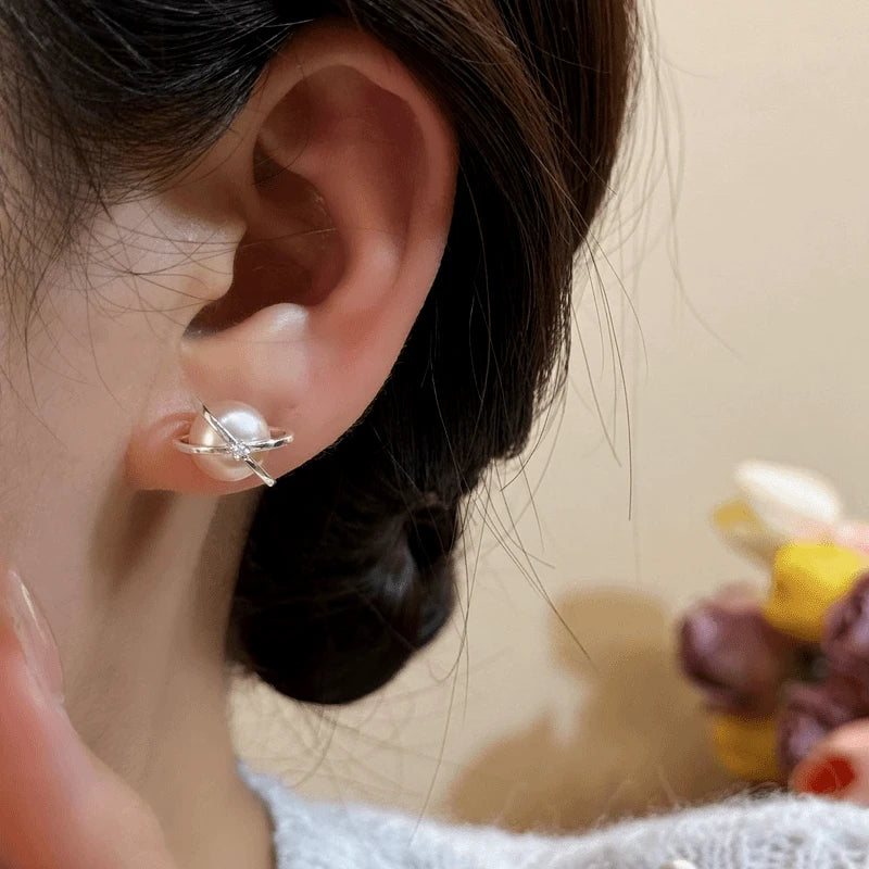 Close-up detail of the sparkling zircons and plating on the gold pearl earrings