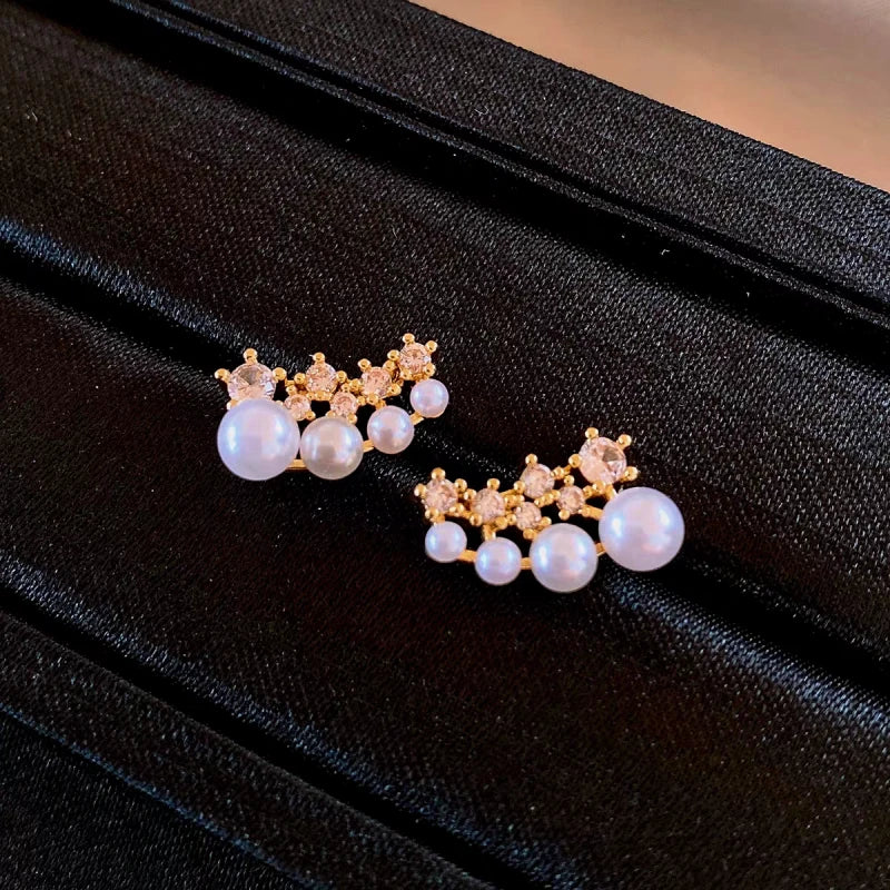 Close-up detail of the sparkling zircons and plating on the gold pearl earrings