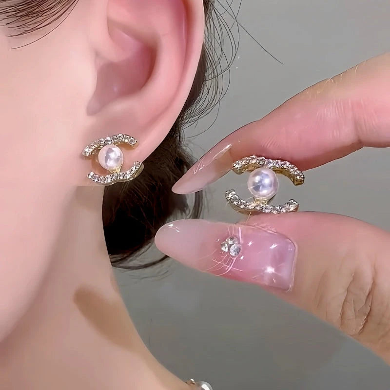 Model showcasing the dangle and style of the 14K Gold-Plated Elegant Zircon Pearl Stud Earrings