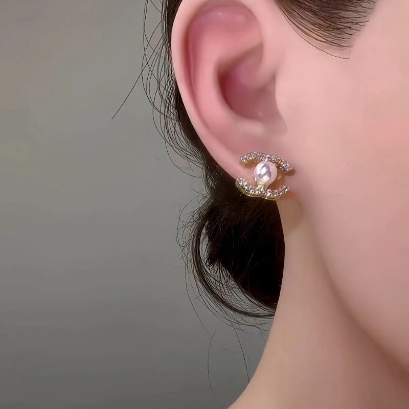 Close-up detail of the sparkling zircons and plating on the gold pearl earrings