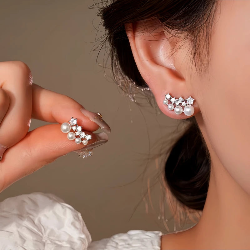 Model showcasing the dangle and style of the 14K Gold-Plated Elegant Zircon Pearl Stud Earrinhgs