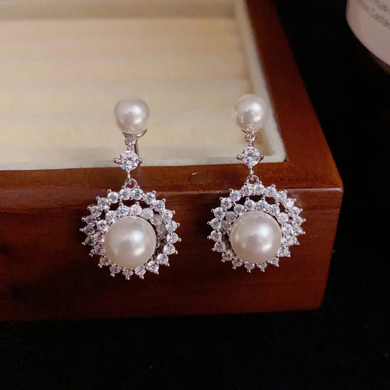 Angled view of the 14K Gold-Plated Elegant Zircon Pearl Sunflower Earrings
