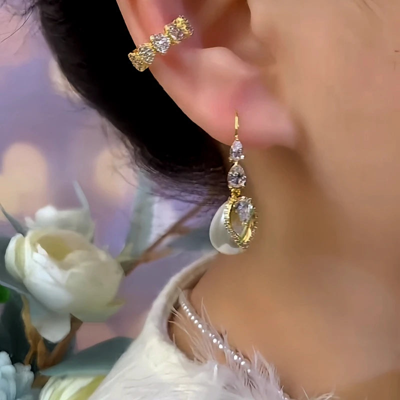 Close-up detail of the sparkling zircons and plating on the gold pearl earrings
