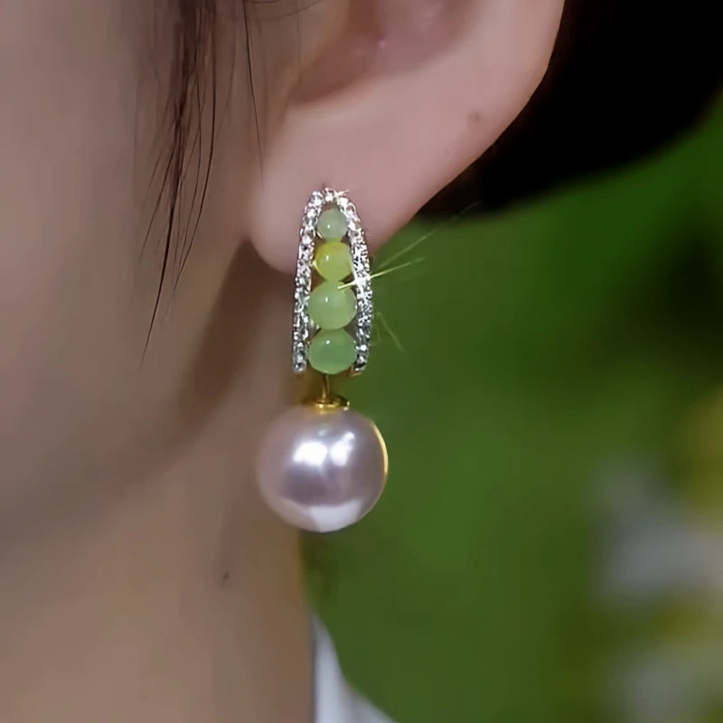 Model showcasing the dangle and style of the 14K Gold-Plated Elegant Zircon Pearls Earrings