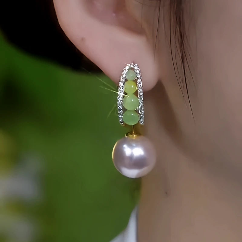 Close-up detail of the sparkling zircons and plating on the gold pearl earrings