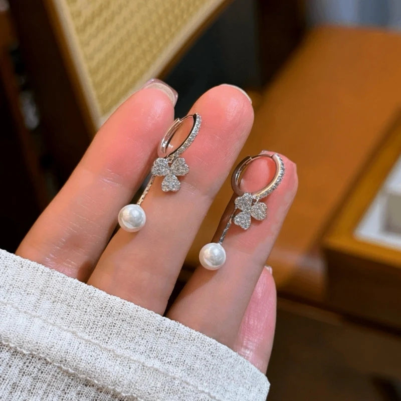 Model showcasing the dangle and style of the 14K Gold-Plated Elegant Zircon Petal Flower Bead Earrings