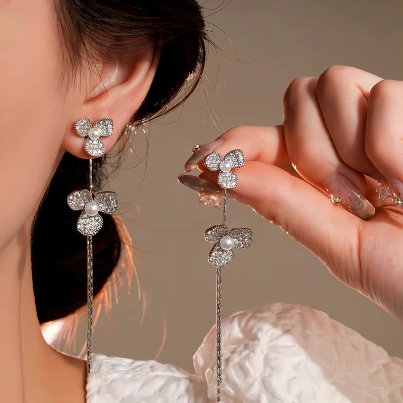 Model showcasing the dangle and style of the 14K Gold-Plated Elegant Zircon Petal Flower Tassel Earrings