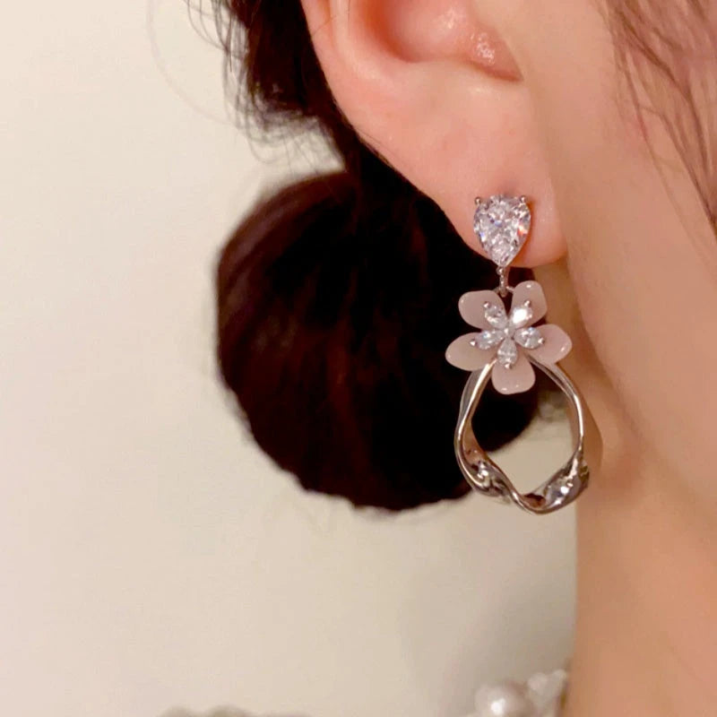 Model showcasing the dangle and style of the 14K Gold-Plated Elegant Zircon Petal Geometric Tassel Earrings