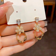 Close-up detail of the sparkling zircons and plating on the Geometric Tassel Earrings