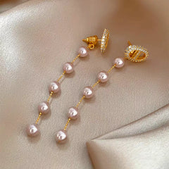 Angled view of the 14K Gold-Plated Elegant Zircon Pig Nose Pearl Earrings