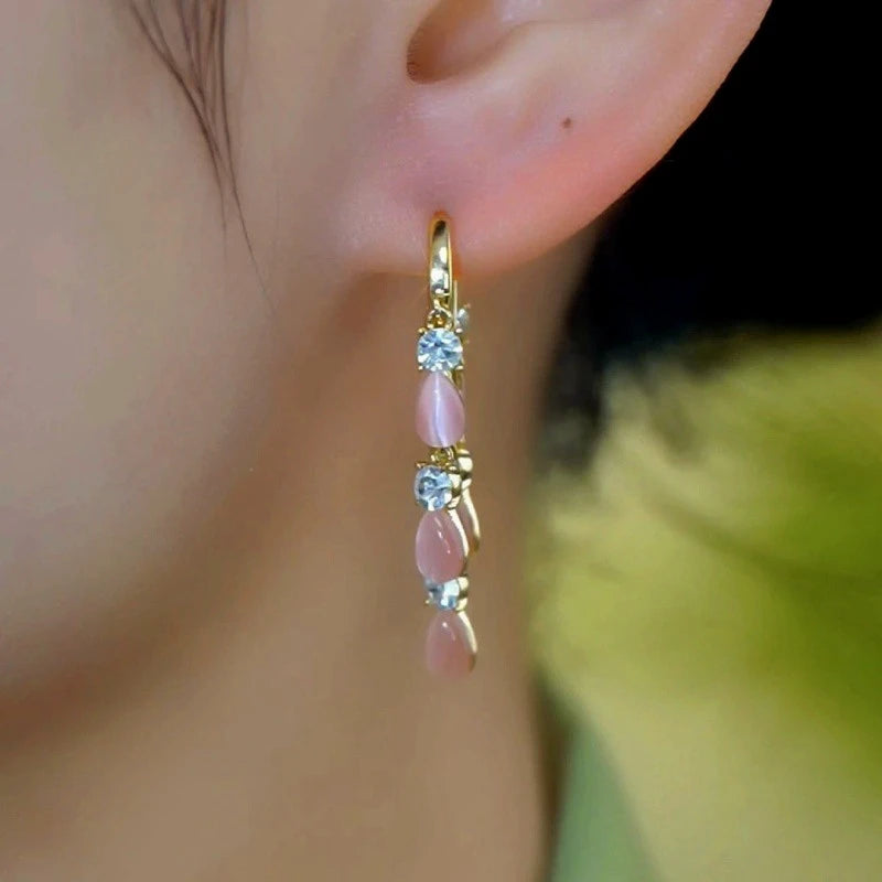 Close-up detail of the sparkling zircons and plating on the Cat's Eye Tassel Earrings