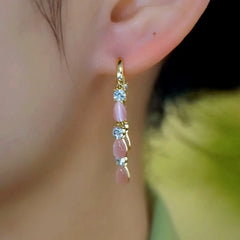 Close-up detail of the sparkling zircons and plating on the Cat's Eye Tassel Earrings