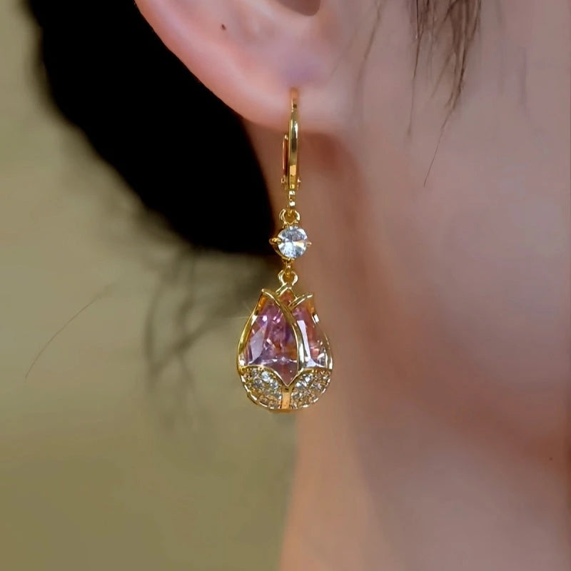Model showcasing the dangle and style of the 14K Gold-Plated Elegant Zircon Pink Diamond Tulip Earrings