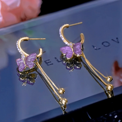 Angled view of the 14K Gold-Plated Elegant Zircon Purple Crystal Butterfly Earrings