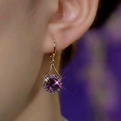 Model showcasing the dangle and style of the 14K Gold-Plated Elegant Zircon Purple Crystal Earrings