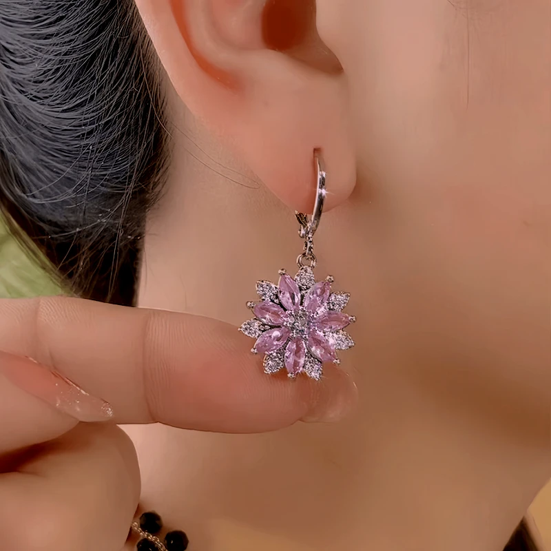 Model showcasing the dangle and style of the 14K Gold-Plated Elegant Zircon Purple Crystal Flower Earrings