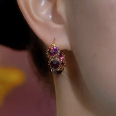 Model showcasing the dangle and style of the 14K Gold-Plated Elegant Zircon Purple Crystal Hoop Earrings