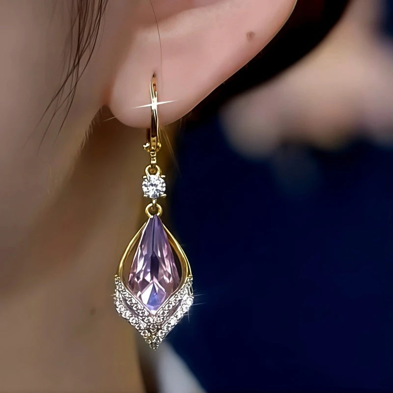 Model showcasing the dangle and style of the 14K Gold-Plated Elegant Zircon Purple Crystal Water Drop Earrings