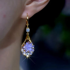 Model showcasing the dangle and style of the 14K Gold-Plated Elegant Zircon Purple Crytal Water Drop Earrings