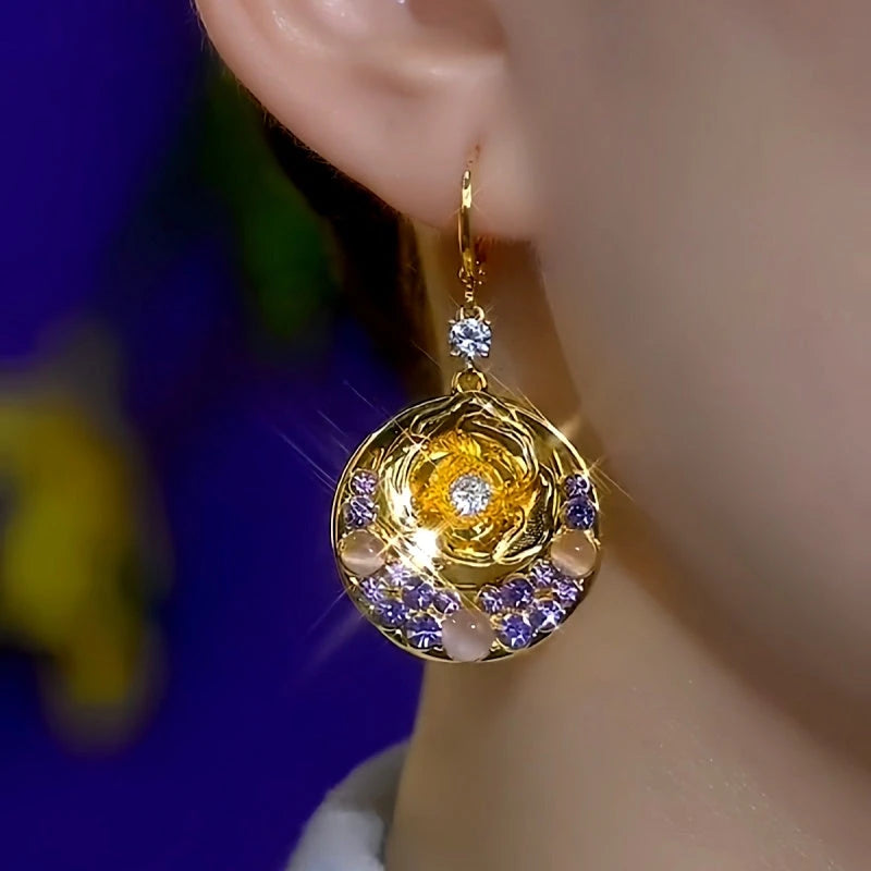 Model showcasing the dangle and style of the 14K Gold-Plated Elegant Zircon Purple Diamond Cat's Eye Stone Rose Earrings
