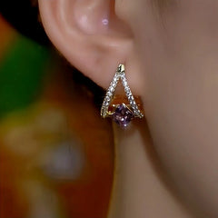 Model showcasing the dangle and style of the 14K Gold-Plated Elegant Zircon Purple Diamond Earrings