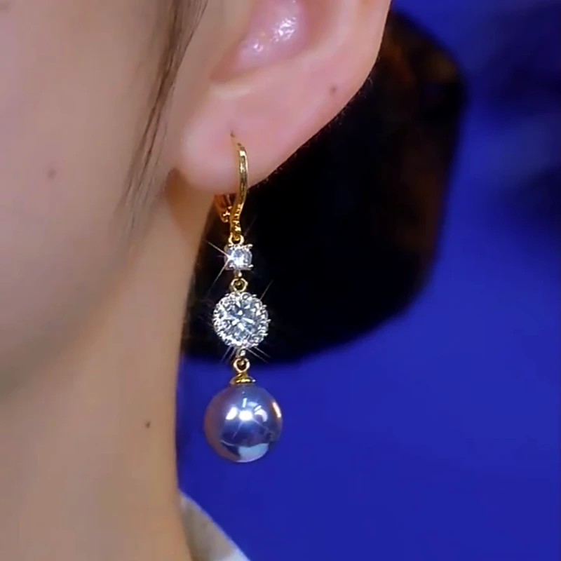Model showcasing the dangle and style of the 14K Gold-Plated Elegant Zircon Purple Pearl Earrings