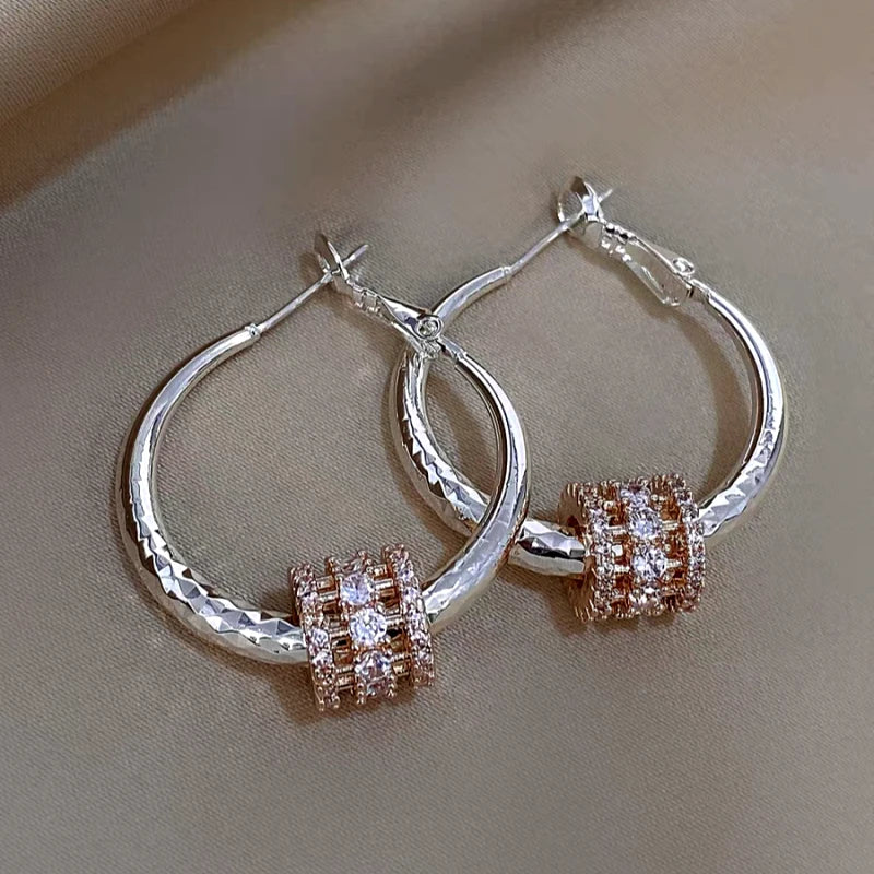 Model showcasing the dangle and style of the 14K Gold-Plated Elegant Zircon Ring Hoop Earrings