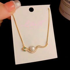 Close-up of the pendant and clasp on the Pearl Snake Necklace