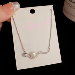 Detailed view of the 14K Gold-Plated Elegant Zircon Ripple Pearl Snake Necklace chain and pendant