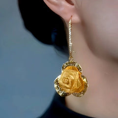 Model showcasing the dangle and style of the 14K Gold-Plated Elegant Zircon Rose Ear Buckle Earrings
