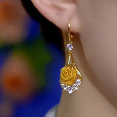 Model showcasing the dangle and style of the 14K Gold-Plated Elegant Zircon Rose Earrings