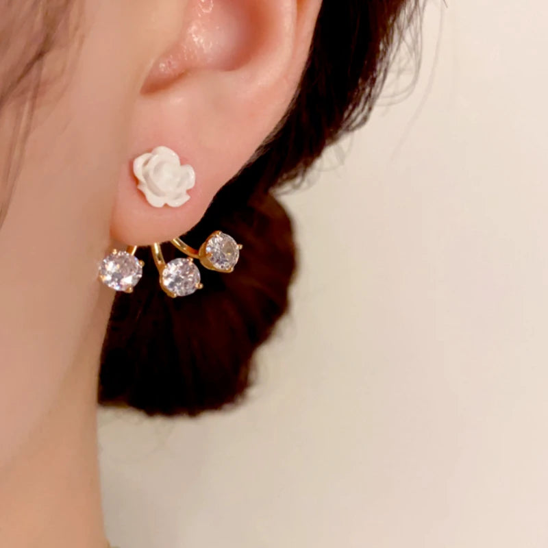 Model showcasing the dangle and style of the 14K Gold-Plated Elegant Zircon Rose Jacket Earrings