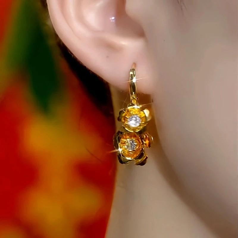 Model showcasing the dangle and style of the 14K Gold-Plated Elegant Zircon Rose Lady Tassel Earrings