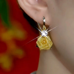 Model showcasing the dangle and style of the 14K Gold-Plated Elegant Zircon Rose Tassel Earrings