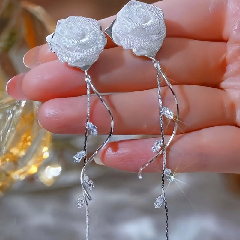 Model showcasing the dangle and style of the 14K Gold-Plated Elegant Zircon Rose Tassel Earrings