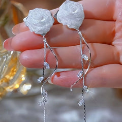 Model showcasing the dangle and style of the 14K Gold-Plated Elegant Zircon Rose Tassel Earrings