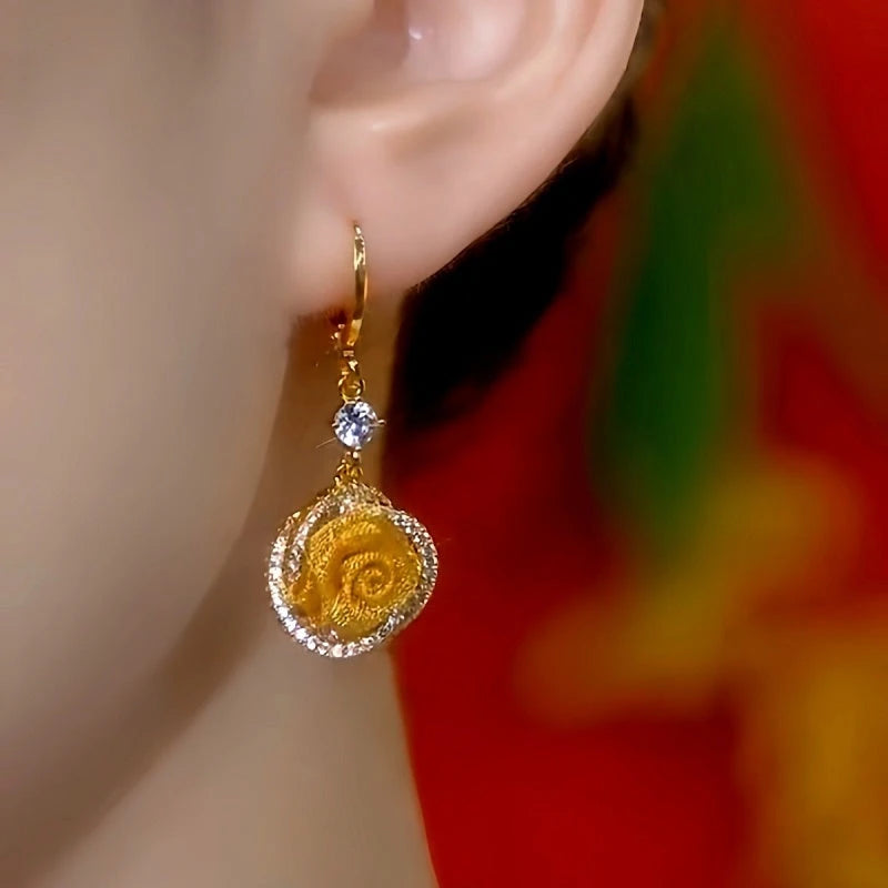 Model showcasing the dangle and style of the 14K Gold-Plated Elegant Zircon Rose Tassel Earrings