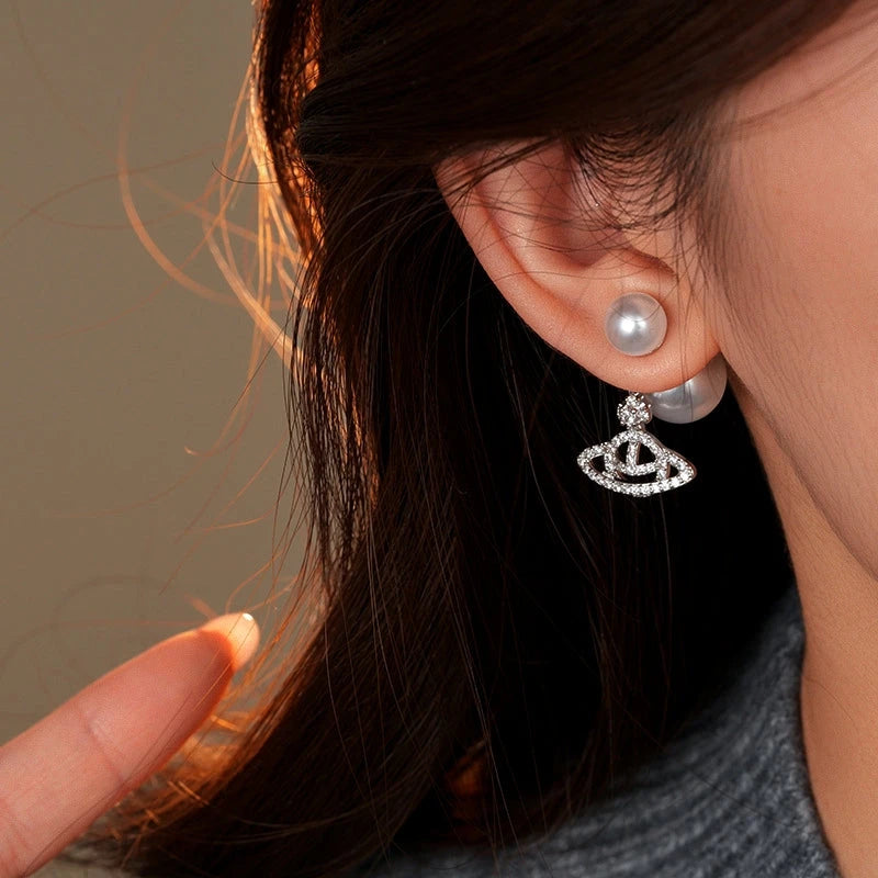 Model showcasing the dangle and style of the 14K Gold-Plated Elegant Zircon Saturn Pearls Earrings