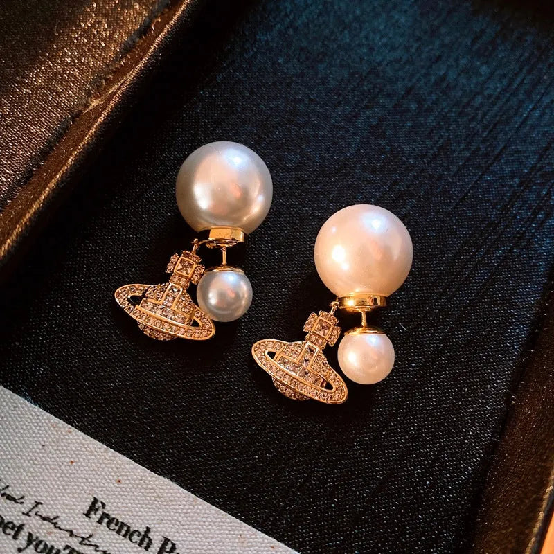 Angled view of the 14K Gold-Plated Elegant Zircon Saturn Pearls Earrings