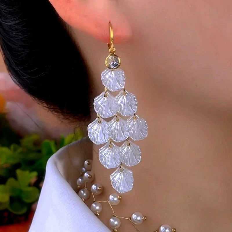 Model showcasing the dangle and style of the 14K Gold-Plated Elegant Zircon Shell Earrings