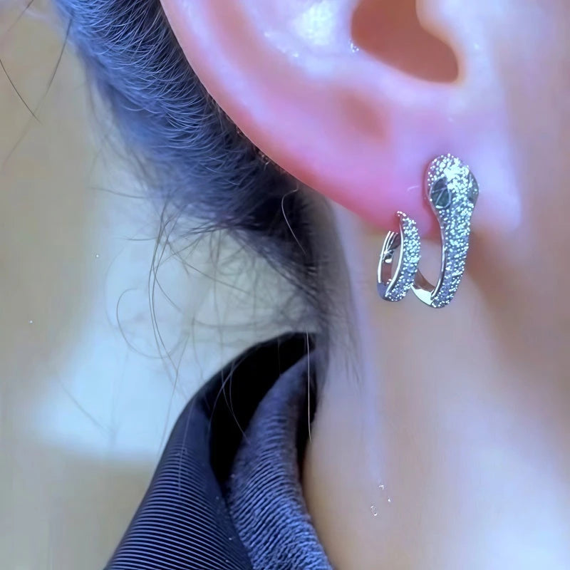 Model showcasing the dangle and style of the 14K Gold-Plated Elegant Zircon Snake-Design Earrings