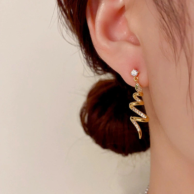 Model showcasing the dangle and style of the 14K Gold-Plated Elegant Zircon Snake-Shaped Spiral Earrings