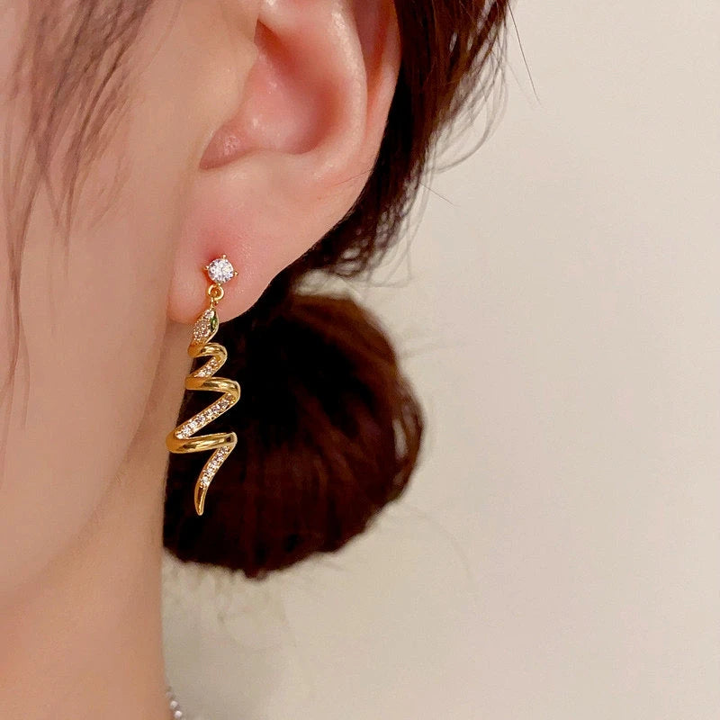 Close-up detail of the sparkling zircons and plating on the Spiral Snake Earrings